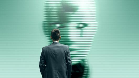 Ein Mann starrt auf einen humanoiden KI-Roboter.