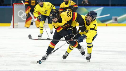 Lilli Welcke und Mira Jungaker kämpfen um den Puck.