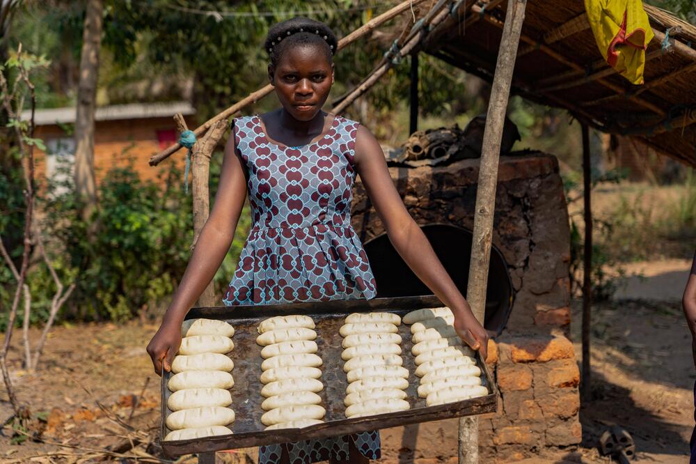 Ein junges Mädchen mit frischgebackenem Brot in der Demokratischen Republik Kongo