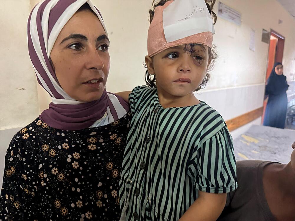 Ein verletztes Kind auf dem Arm der Mutter